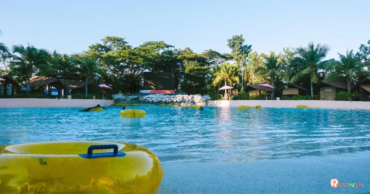 Sitting on a float and playing in the waves in the pool